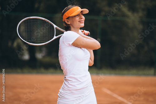Young woman tennis player at the court © Petro