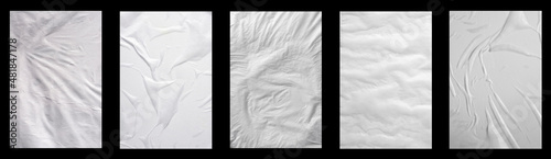 Five sheets of white crumpled paper on a black background.