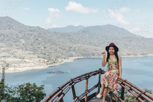 Young pretty Asian woman feeling relax with ocean and mountain view in Wanagiri, Bali. Tourist concept. © Karlie Studio