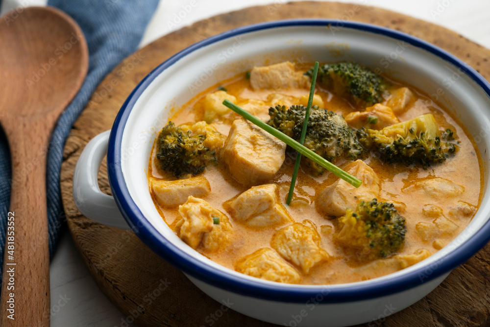 Chicken cooked in curry with broccoli and coconut milk. Chicken cooked in curry with broccoli and coconut milk.