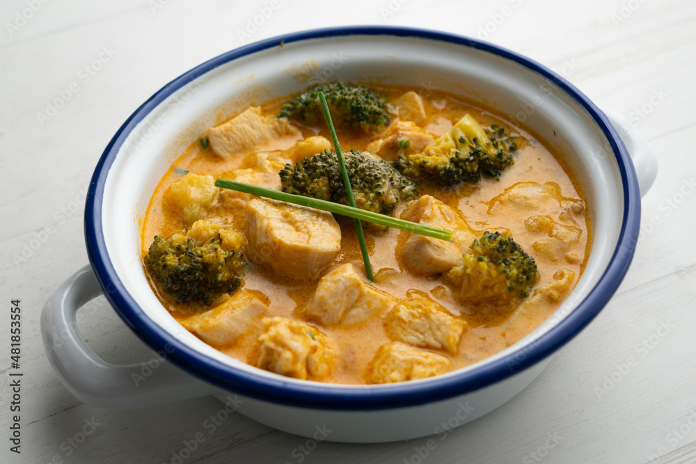 Chicken cooked in curry with broccoli and coconut milk. Chicken cooked in curry with broccoli and coconut milk.