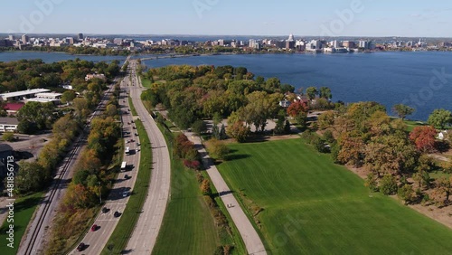 In Olin Park Flying Over John Nolen Drive towards Downtown Madison, Wisconsin Surrounded by Fall Colors (Drone - Push In)