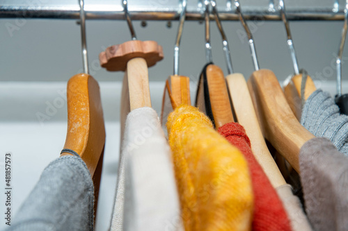 Colourful clothes in the wardrobe with moth protection made of Swiss pine photo