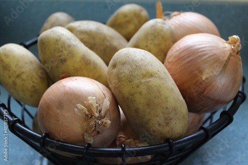 onions and potatoes in a basket