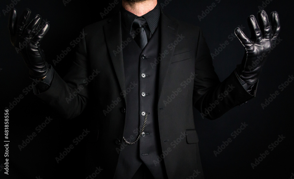 Portrait of Man in Dark Suit and Leather Gloves on Black Background. Mafia Hit Man or Criminal Gangster Concept.
