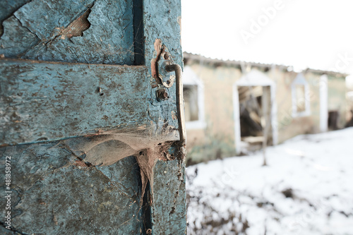 Old door handle with cobweb in old abandoned yard © Irene Fox