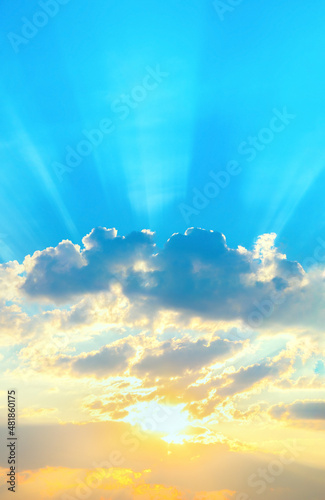 Sunrise sky with sun golden rays breaking through the dark clouds. Nature background. Hope concept