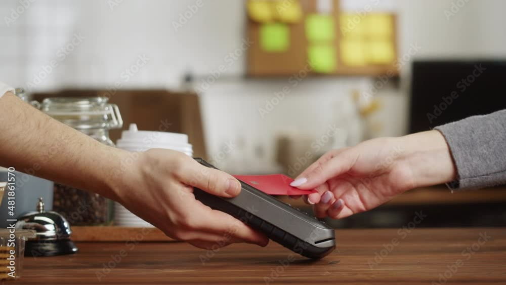 Paying with credit bank card in cafe. Touch-free and contactless food shopping in restaurant. NFC technology concept. 