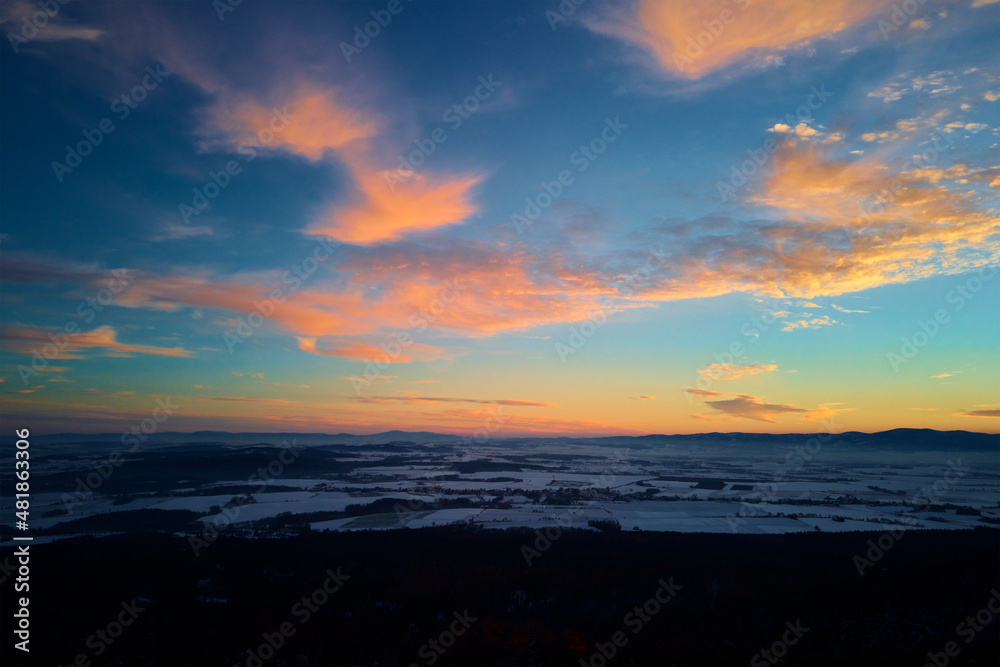 Sunset over mountans covered with forest, beautiful winter landscape, nature background, aerial view
