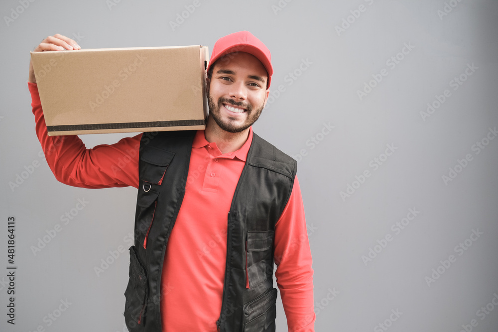 Courier man delivery box while smiling on camera