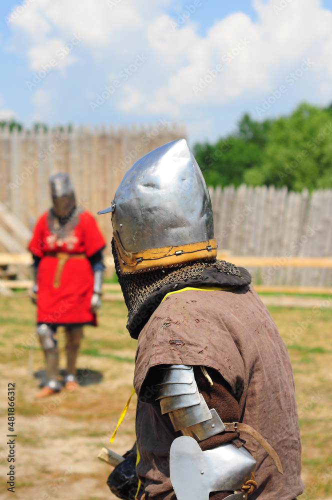 Two knights in armor before the battle, reconstruction of a jousting tournament. Holiday Ivan Kupala, Slavic traditions. faces are not visible