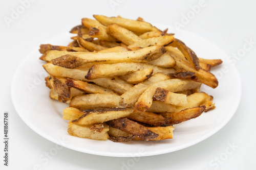 Hand Cut French Fries with the Skin on on a White Plate