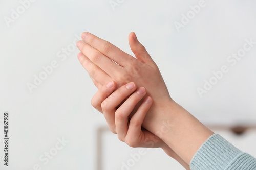 Hands of beautiful young woman at home