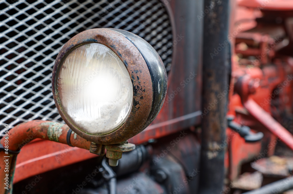 Fototapeta premium Rusted headlights on an old tractor.