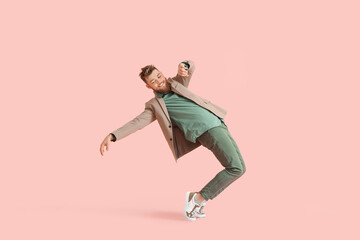 Cool dancing young man on color background