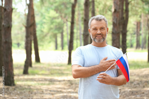 Handsome mature man with flag of Russia outdoors