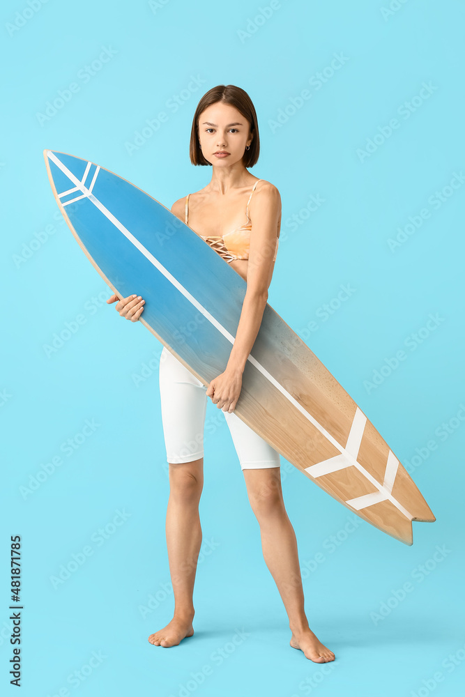 Beautiful young woman with surfboard on color background Stock Photo