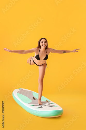 Young woman practicing yoga...