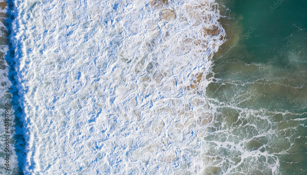 Aerial view of Atlantic waves breaking in south Spain at a winter evening. Surfer swell waves breaking elegantly Aerial view of Atlantic waves breaking in south Spain at a winter evening. Surfer swell waves breaking elegantly