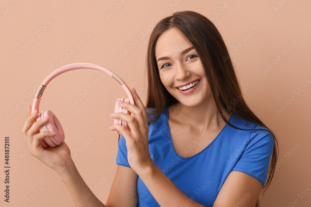 Cool young woman with headphones on color background Cool young woman with headphones on color background