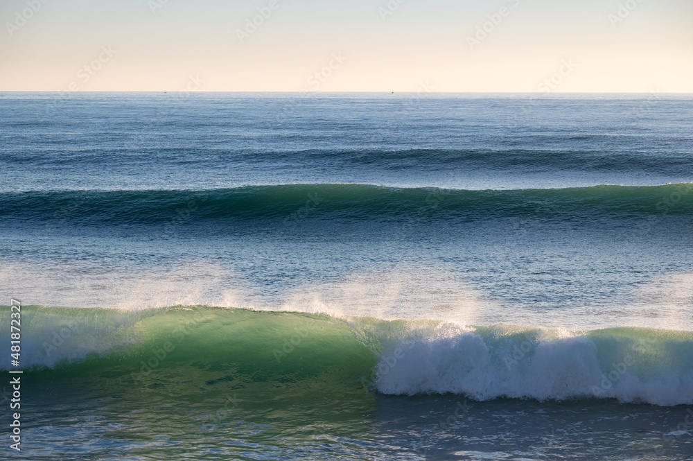 Beautiful Atlantic waves breaking in south Spain at a winter evening. Surfer swell waves breaking elegantly Beautiful Atlantic waves breaking in south Spain at a winter evening. Surfer swell waves breaking elegantly