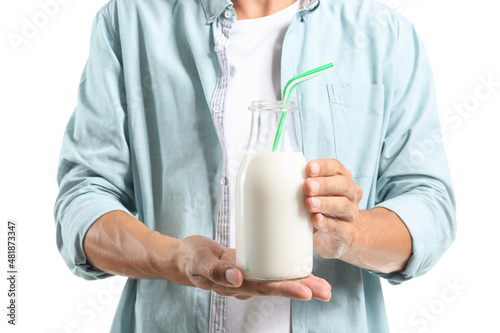 Young man with bottle of milk on white background  closeup