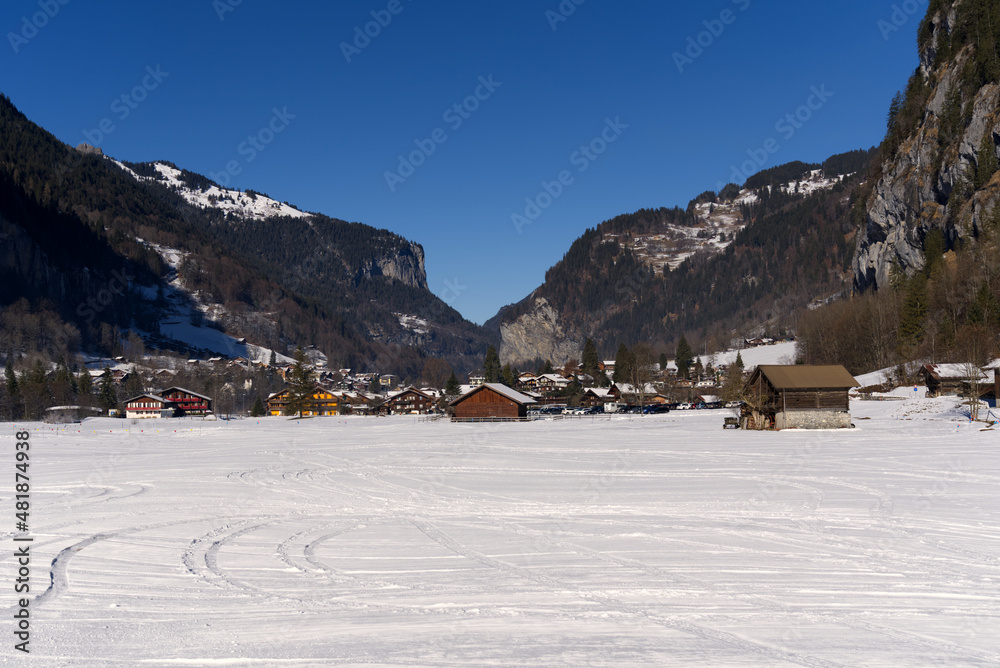 Mountain valley Lauterbrunnen in the Swiss Alps on a sunny winter day with mountain panorama in the background. Photo taken January 15th, 2022, Lauterbrunnen, Switzerland. Mountain valley Lauterbrunnen in the Swiss Alps on a sunny winter day with mountain panorama in the background. Photo taken January 15th, 2022, Lauterbrunnen, Switzerland.