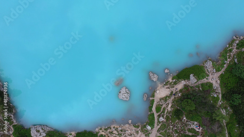 Lago di Sorapis lake. Blue water and grass. Dron view.