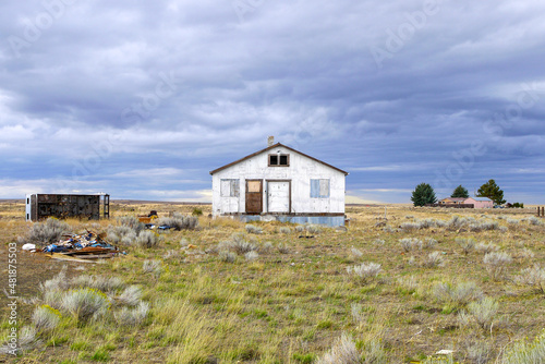 old house facade of an abandoned house on a field with thunderstorm clouds  Kent  Oregon  USA