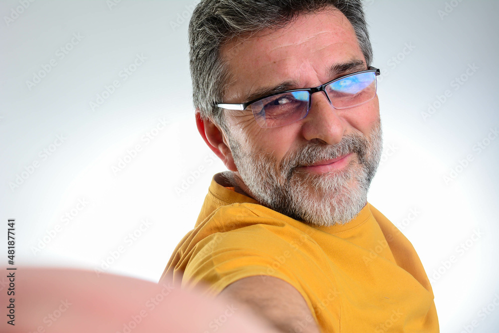 Close up portrait of a cheerful mature bearded man taking selfie Close up portrait of a cheerful mature bearded man taking selfie