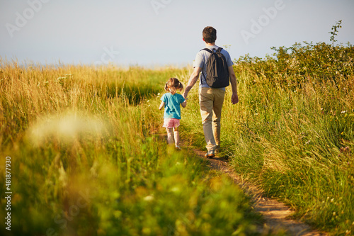 Father and daughter hiking near Mers-les-Bains, France