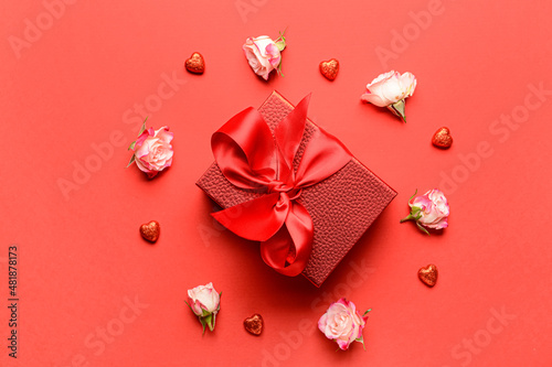 Gift for Valentine s Day and flowers on red background