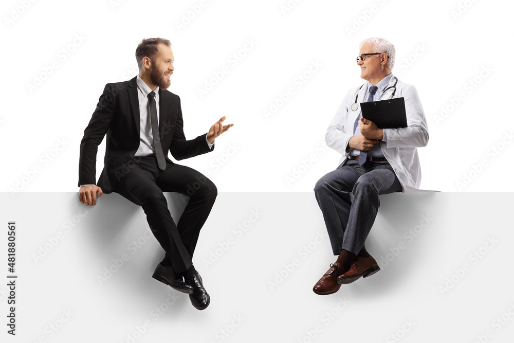 Young businessman sitting on a panel and talking to a mature male doctor Young businessman sitting on a panel and talking to a mature male doctor