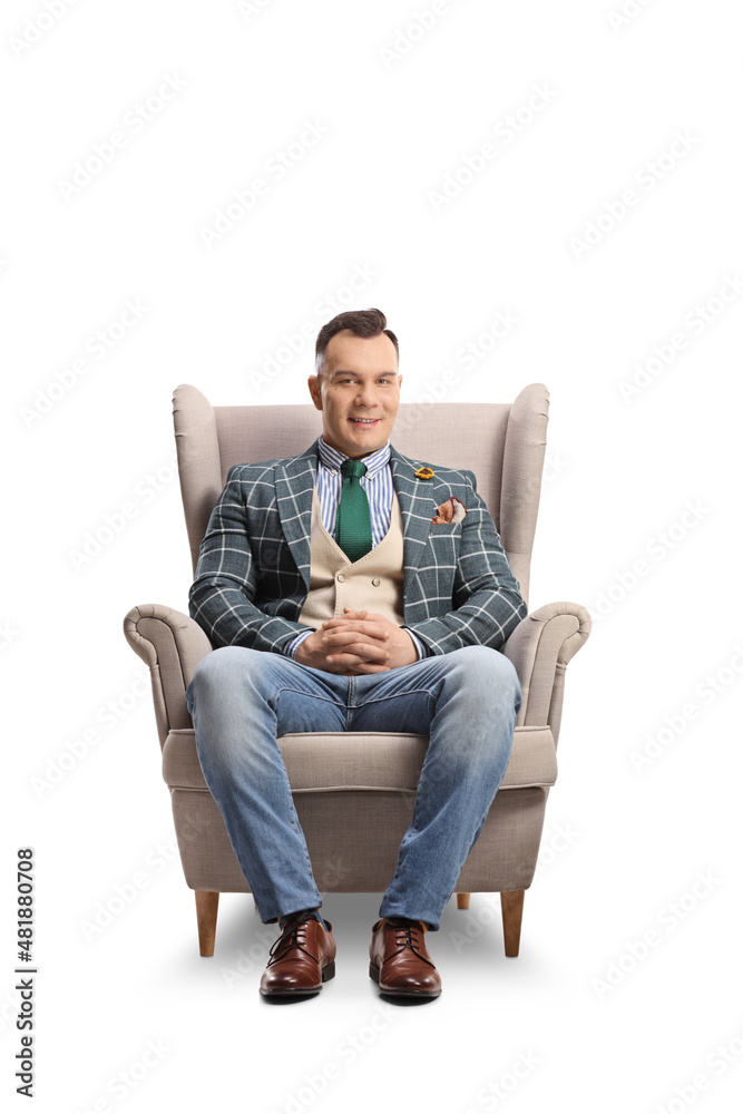 Fashionable man sitting in an armchair