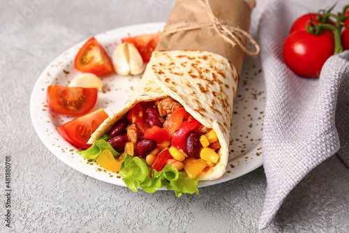 Plate with delicious burrito on grey background, closeup