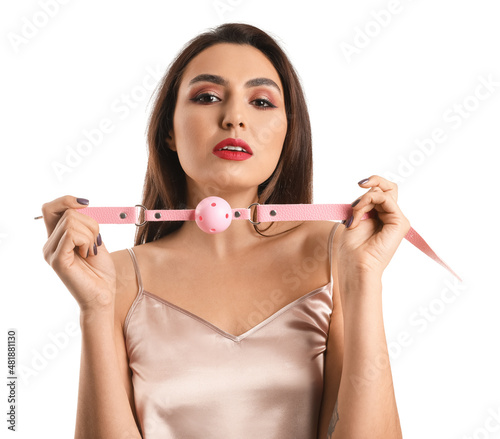 Young woman with mouth gag on white background