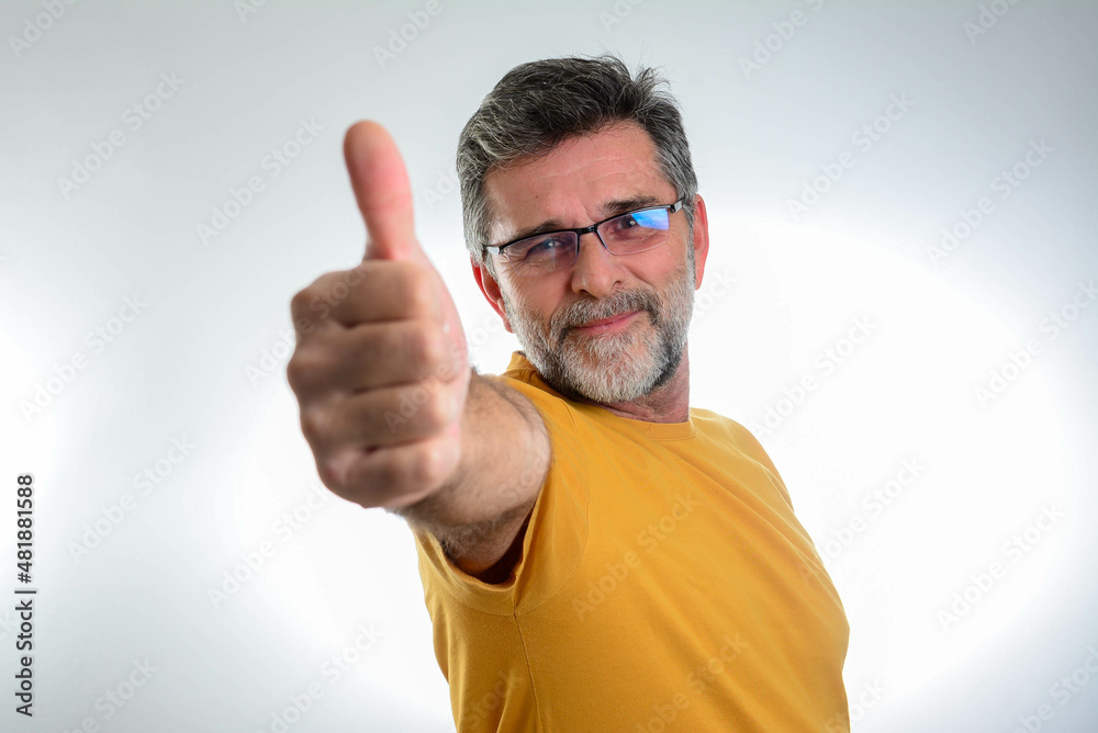 Happy handsome mature man showing thumbs up Happy handsome mature man showing thumbs up
