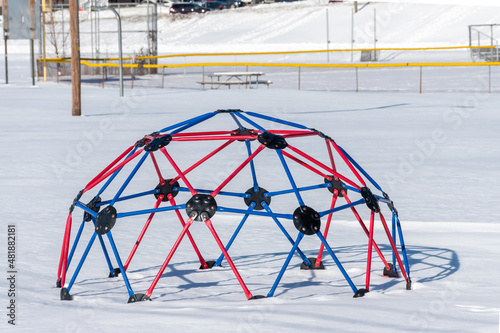 Dome monkey bars in a playground after heavy snow go unused. photo