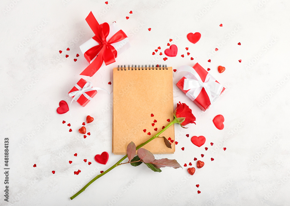 Blank notebook, rose flower and gifts for Valentine's Day on light background Blank notebook, rose flower and gifts for Valentine's Day on light background