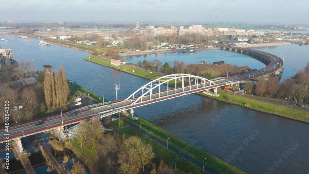 Aerial hyperlapse of the Enneus Heermabrug near Ijburg in Amsterdam The Netherlands. Traffic going over the bridge. Dutch infrastructure. Aerial hyperlapse of the Enneus Heermabrug near Ijburg in Amsterdam The Netherlands. Traffic going over the bridge. Dutch infrastructure.