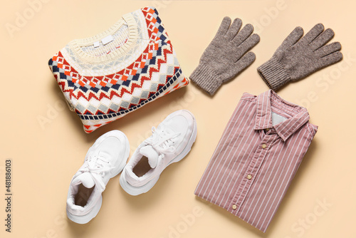 Stylish male clothes, gloves and shoes on color background