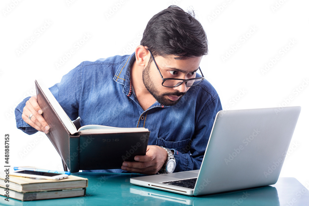single person looking at laptop screen holding diary on hand in isolated background single person looking at laptop screen holding diary on hand in isolated background
