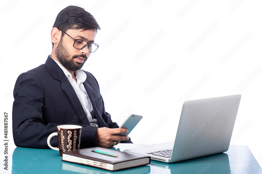 distracted lawyer busy with mobile phone sitting in front of laptop in isolated background distracted lawyer busy with mobile phone sitting in front of laptop in isolated background