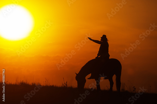 silhouette of a woman riding a horse