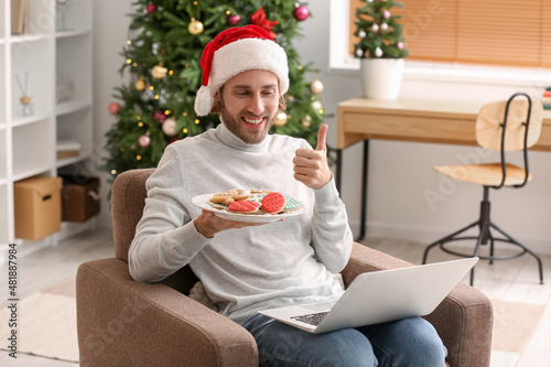 Young man in Santa hat with...