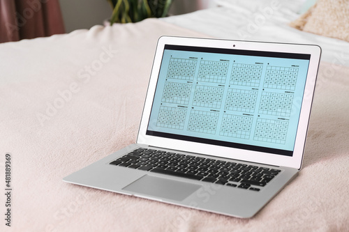 Laptop with calendar on bed...