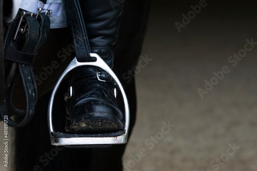 Detail of a stirrup and boot in dressage photo