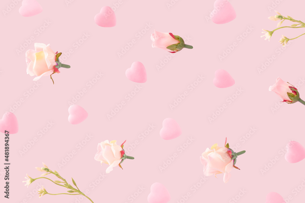 Romantic composition made with flying bright pink hearts and rose flowers against pastel pink background. Creative love concept. Valentines celebration aesthetic. Romantic composition made with flying bright pink hearts and rose flowers against pastel pink background. Creative love concept. Valentines celebration aesthetic.