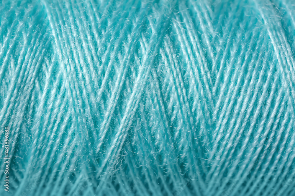 Turquoise sewing threads as background Turquoise sewing threads as background