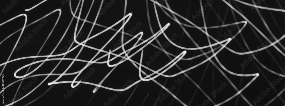 Abstract painting with white light on black. Waves and curved lines. Creativity.
